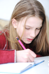 Girl in foster care writing