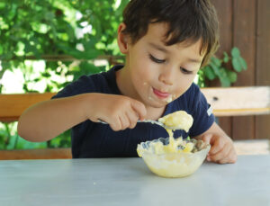 cute little kid eating ice cream and enjoying SBI 300980162