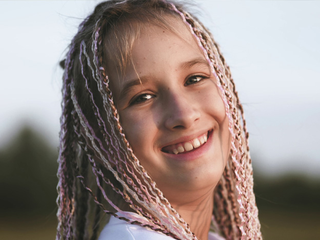 portrait of a cute teenage girl with african braids